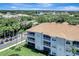 Scenic aerial view of condo complex with palm trees and beautiful landscaping under a clear blue sky at 1000 San Lino Cir # 1034, Venice, FL 34292