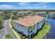 An aerial view of condo buildings that feature lake views and manicured landscaping at 1000 San Lino Cir # 1034, Venice, FL 34292