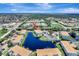 Beautiful aerial view of a lakeside condo community, featuring well-maintained landscaping and serene water views at 1000 San Lino Cir # 1034, Venice, FL 34292