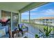Relaxing screened balcony with outdoor seating overlooking a pond and nearby buildings at 1000 San Lino Cir # 1034, Venice, FL 34292