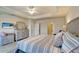 Bright and open bedroom featuring a queen bed, dresser, and neutral decor at 1000 San Lino Cir # 1034, Venice, FL 34292