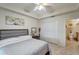 This bedroom provides comfortable decor, a closet for storage, and an en suite bathroom at 1000 San Lino Cir # 1034, Venice, FL 34292
