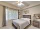 A comfortably sized bedroom features neutral decor, a ceiling fan, and lots of natural light at 1000 San Lino Cir # 1034, Venice, FL 34292