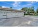 Exterior view of attached two-car garages featuring white doors and the building number at 1000 San Lino Cir # 1034, Venice, FL 34292