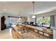 Elegant kitchen with granite countertops, a breakfast bar, and views into the living spaces at 1000 San Lino Cir # 1034, Venice, FL 34292
