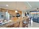 A spacious kitchen features granite countertops and an adjacent living area with a water view at 1000 San Lino Cir # 1034, Venice, FL 34292