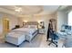 This spacious main bedroom features a tray ceiling, an en suite bath, and tile flooring at 1000 San Lino Cir # 1034, Venice, FL 34292