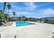 Community outdoor pool with lounge chairs and lush landscaping on a sunny day at 1000 San Lino Cir # 1034, Venice, FL 34292