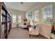 Cozy reading room with large bookshelves, comfortable chairs, and natural light from the windows at 1000 San Lino Cir # 1034, Venice, FL 34292