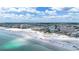 Aerial view showcasing the beach with white sand, clear water, and surrounding buildings at 1201 Big Oak Ln, Sarasota, FL 34242