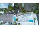 Aerial view of a home, with a pool, dock, and lush tropical landscaping on a waterfront property at 1201 Big Oak Ln, Sarasota, FL 34242