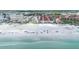 Scenic aerial view of the beach featuring clear water, white sand, and a vibrant cityscape at 1201 Big Oak Ln, Sarasota, FL 34242