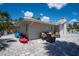 Backyard showing a paved patio, outdoor seating, and kayaks near a waterfront area at 1201 Big Oak Ln, Sarasota, FL 34242