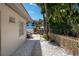 Charming outdoor patio and garden with fence and abundant shade from tropical trees at 1201 Big Oak Ln, Sarasota, FL 34242