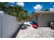 Backyard with a paved patio and kayaks next to a fenced waterfront area at 1201 Big Oak Ln, Sarasota, FL 34242
