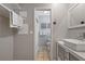 Bright bathroom features a vessel sink, neutral paint, and an open doorway to the shower area at 1201 Big Oak Ln, Sarasota, FL 34242
