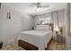 Cozy bedroom with wood-look floors, closet, and a ceiling fan; a peaceful space for rest at 1201 Big Oak Ln, Sarasota, FL 34242