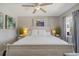 Bright bedroom featuring a ceiling fan, a comfortable bed, and serene decor at 1201 Big Oak Ln, Sarasota, FL 34242