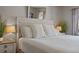 Bright bedroom featuring a ceiling fan, a comfortable bed, and serene decor at 1201 Big Oak Ln, Sarasota, FL 34242