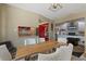 Open dining room featuring a wood table, white chairs, and views to the kitchen and living room at 1201 Big Oak Ln, Sarasota, FL 34242