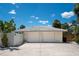 Garage with two doors featuring a concrete driveway and white tile roof at 1201 Big Oak Ln, Sarasota, FL 34242