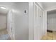 A hallway with tan floors, a closet, and doorways to other rooms in the home at 1201 Big Oak Ln, Sarasota, FL 34242