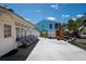 A waterfront patio with gray chairs, outdoor furniture and view of tropical vegetation at 1201 Big Oak Ln, Sarasota, FL 34242