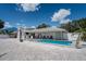 Inviting backyard with a sparkling pool, comfortable lounge area, and a charming shell-covered yard at 1201 Big Oak Ln, Sarasota, FL 34242