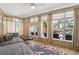Inviting sunroom with many windows, comfortable seating, and serene waterfront views at 1201 Big Oak Ln, Sarasota, FL 34242