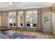 Relaxing sunroom with a cozy sofa, a ceiling fan, and a view of the water from the many windows at 1201 Big Oak Ln, Sarasota, FL 34242