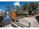 Waterfront patio featuring landscaping, boat dock, and tropical foliage at 1201 Big Oak Ln, Sarasota, FL 34242