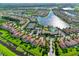 Aerial view showcasing a well-maintained community with a pool, tennis courts, and waterways at 1251 Burgos Dr # 303, Sarasota, FL 34238
