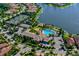 Aerial view of the community showcasing the clubhouse, tennis courts, pool, and surrounding homes at 1251 Burgos Dr # 303, Sarasota, FL 34238