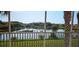 Balcony view overlooking a tranquil pond, palm trees, and verdant foliage at 1251 Burgos Dr # 303, Sarasota, FL 34238