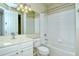 This bathroom features white cabinetry, a large mirror, and a shower-tub combo at 1251 Burgos Dr # 303, Sarasota, FL 34238