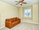 Cozy bedroom featuring neutral carpet and walls, a cushioned window seat, and a ceiling fan at 1251 Burgos Dr # 303, Sarasota, FL 34238