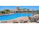 Community pool area with ample seating, palms, and a perfect spot for summer relaxation at 1251 Burgos Dr # 303, Sarasota, FL 34238