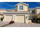Inviting two-story townhome boasts a well-manicured lawn and charming two-car garage at 1251 Burgos Dr # 303, Sarasota, FL 34238