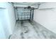 Spacious, empty two-car garage with concrete floor and white walls at 1251 Burgos Dr # 303, Sarasota, FL 34238