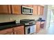 Well-equipped kitchen featuring stainless steel appliances and stylish dark countertops at 1251 Burgos Dr # 303, Sarasota, FL 34238