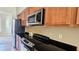 Close up of well-equipped kitchen featuring stainless steel appliances and stylish dark countertops at 1251 Burgos Dr # 303, Sarasota, FL 34238