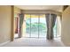 Spacious living area featuring large glass doors leading to a serene outdoor view at 1251 Burgos Dr # 303, Sarasota, FL 34238