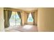 Bright living room with large windows offering scenic views and carpet flooring at 1251 Burgos Dr # 303, Sarasota, FL 34238