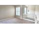 Bright loft area with plush carpeting, neutral walls, and elegant white railing and trim at 1251 Burgos Dr # 303, Sarasota, FL 34238