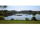 Picturesque view of a tranquil pond surrounded by lush greenery and vegetation at 1251 Burgos Dr # 303, Sarasota, FL 34238