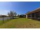 A spacious yard leads to a serene lake view, perfect for outdoor enjoyment at 13026 Ramblewood Trl, Bradenton, FL 34211