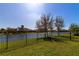 Expansive backyard with serene lake views, perfect for outdoor activities and relaxation at 13026 Ramblewood Trl, Bradenton, FL 34211