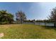 A well-maintained, fenced backyard offers ample green space and views of the nearby lake at 13026 Ramblewood Trl, Bradenton, FL 34211