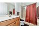 Bathroom featuring a single vanity and a shower-tub combo with striped curtain at 13026 Ramblewood Trl, Bradenton, FL 34211