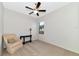 Neutral bedroom with chair, side table, ceiling fan, and a carpeted floor at 13026 Ramblewood Trl, Bradenton, FL 34211
